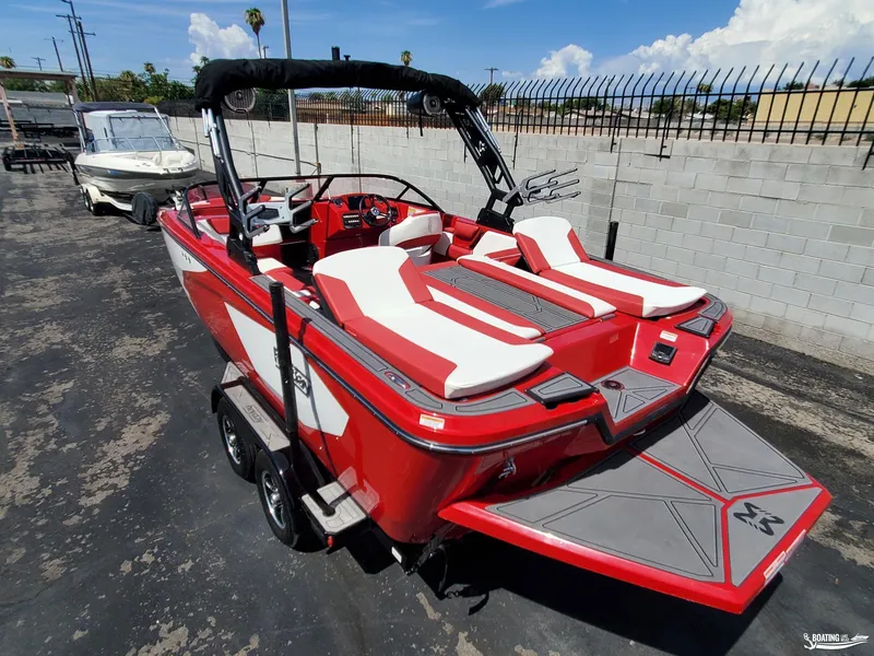 Slide: The Image of Red 2022 Heyday WT-2DC boat with white seating, parked on a trailer. - 11