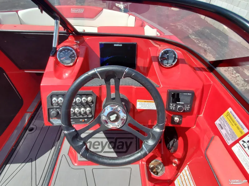 Slide: The Image of 2022 Heyday WT-2DC boat dashboard with steering wheel and control panel. - 14