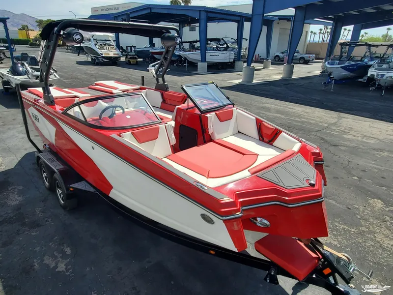 Slide: The Image of 2022 Heyday WT-2DC boat in red and white, parked at a dealership. - 2