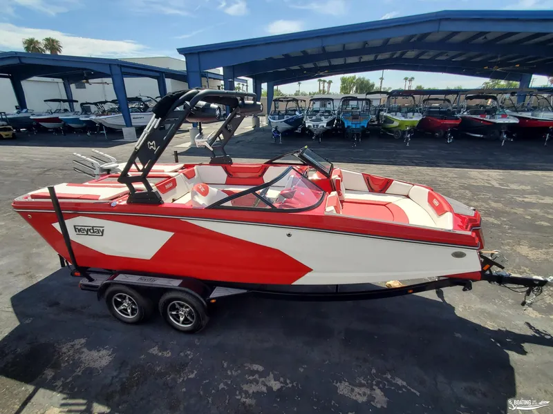 Slide: The Image of 2022 Heyday WT-2DC boat in red and white, parked in a marina. - 4