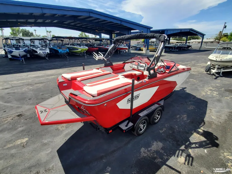 Slide: The Image of 2022 Heyday WT-2DC boat in red and white, parked under a blue canopy. - 5