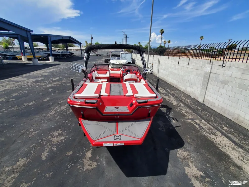Slide: The Image of 2022 Heyday WT-2DC boat, red and white, parked outdoors under a clear blue sky. - 6