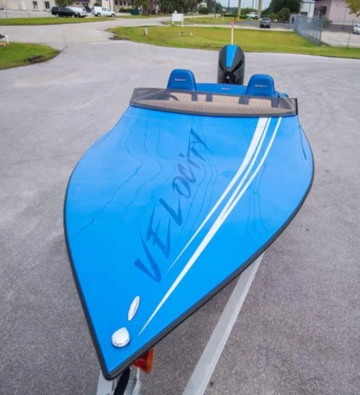 Slide: The Image of 2024 Velocity 230SC blue speedboat on trailer. - 4
