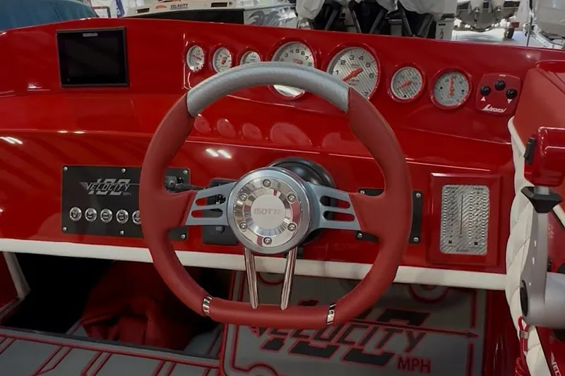 Slide: The Image of Red dashboard of 2026 Velocity 22 Punisher boat with gauges and steering wheel. - 3