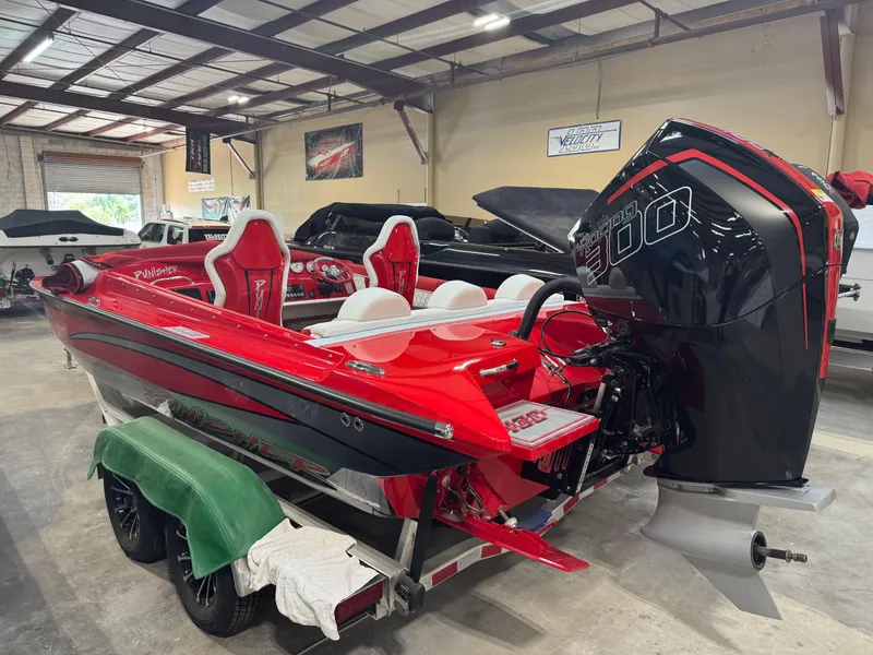 Slide: The Image of Red Velocity 22 Punisher 2026 speedboat with powerful outboard motor in a showroom. - 4