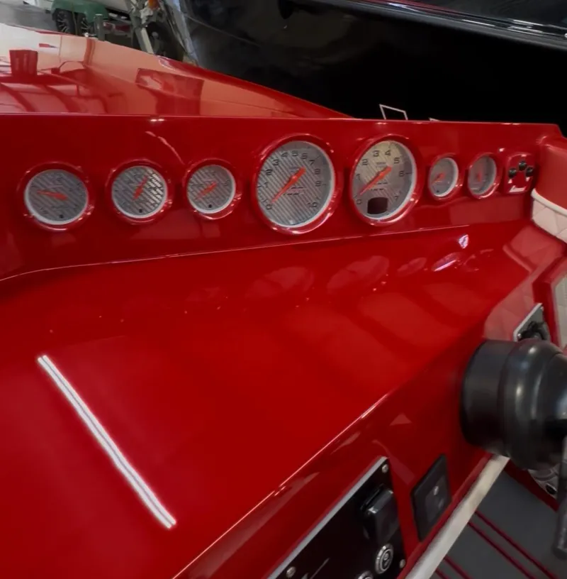Slide: The Image of Red dashboard of 2026 Velocity 22 Punisher boat with multiple gauges and controls. - 5