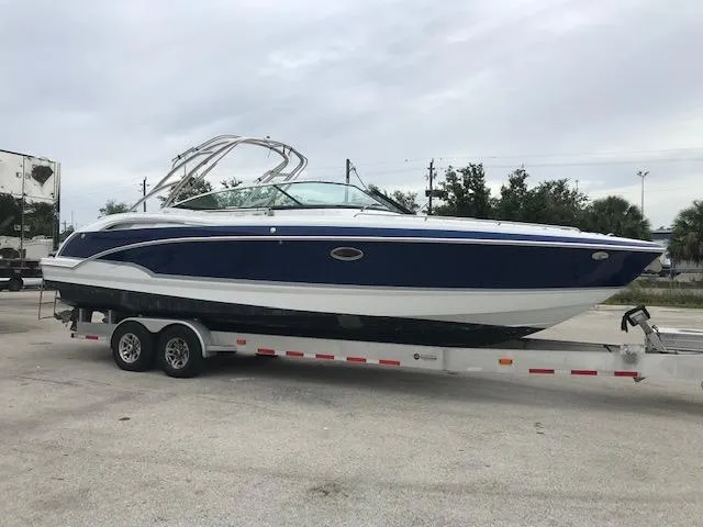 Slide: The Image of 2008 Formula 310 Bowrider boat on a trailer in a parking lot. - 0