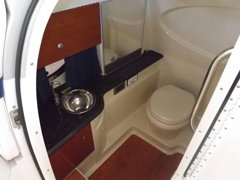 Slide: The Image of 2008 Formula 310 Bowrider bathroom with sink, toilet, and storage cabinets. - 15