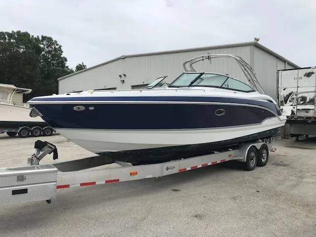 Slide: The Image of 2008 Formula 310 Bowrider boat on a trailer in a storage yard. - 2