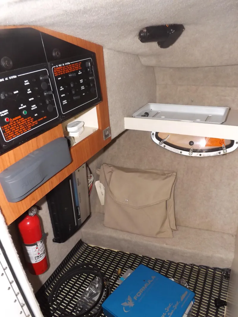 Slide: The Image of Interior cabin of a 2008 Formula 310 Bowrider with control panels and storage. - 25