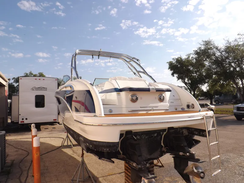 Slide: The Image of 2008 Formula 310 Bowrider boat on a stand, rear view, sunny day. - 4