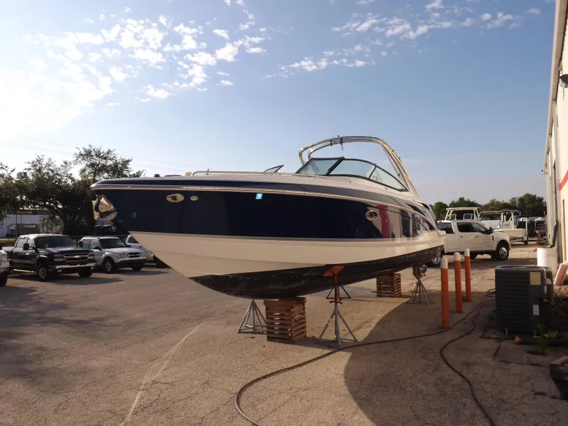 Slide: The Image of 2008 Formula 310 Bowrider boat on stands in a parking lot. - 5