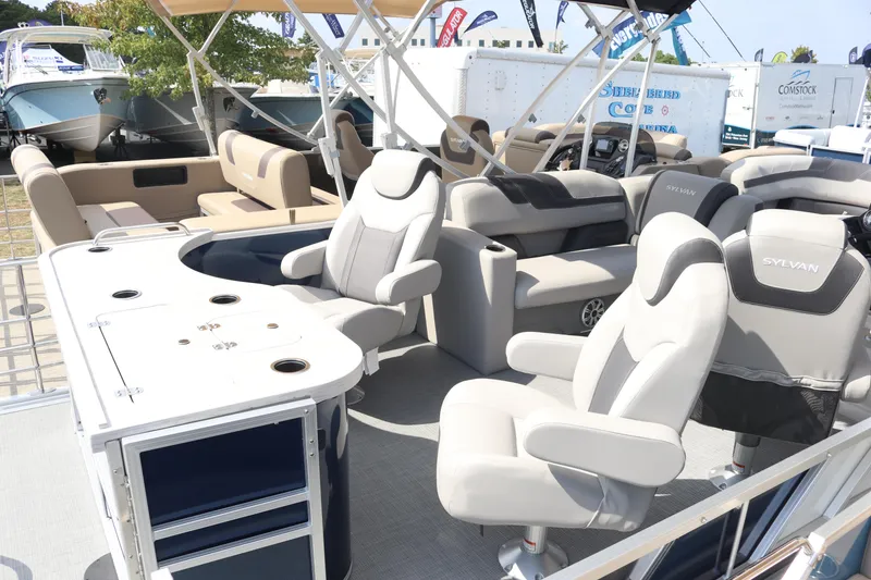 Slide: The Image of 2023 Sylvan L3 ENT pontoon boat interior with plush seating and modern amenities. - 10