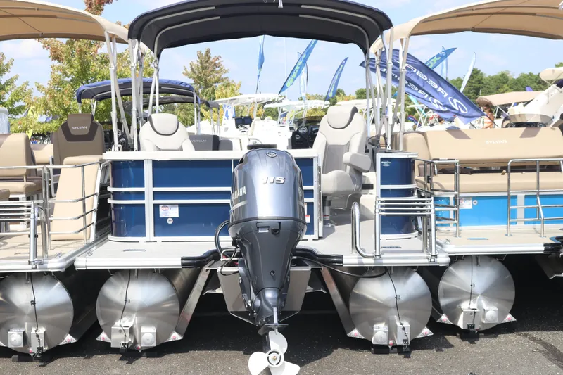 Slide: The Image of 2023 Sylvan L3 ENT pontoon boat with Yamaha outboard motor, displayed outdoors. - 11
