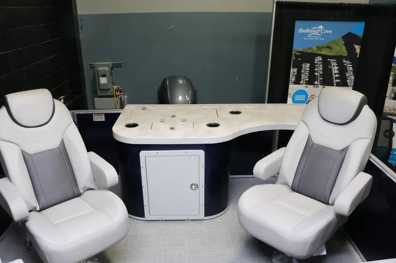 Slide: The Image of 2023 Sylvan L3 ENT boat interior with two white seats and a sleek control panel. - 18