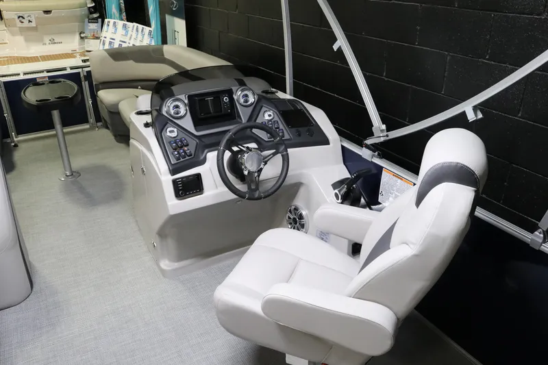 Slide: The Image of 2023 Sylvan L3 ENT boat interior with modern helm and comfortable seating. - 19