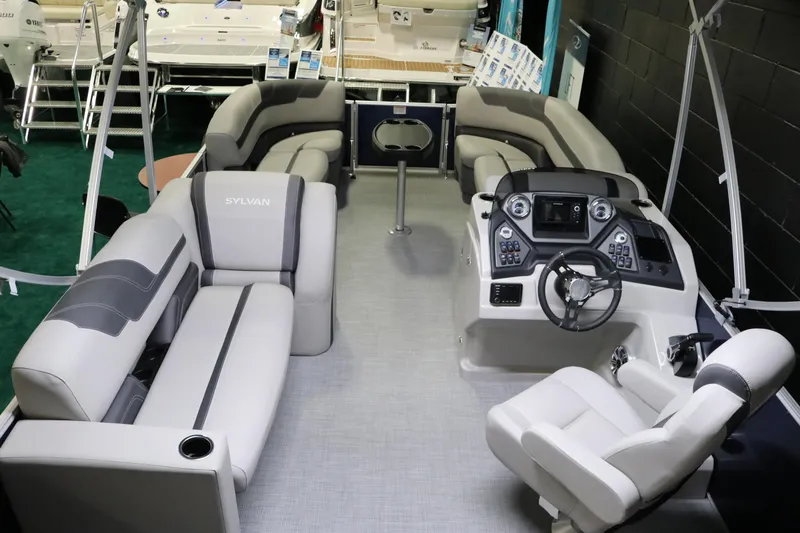 Slide: The Image of 2023 Sylvan L3 ENT pontoon boat interior with plush seating and modern helm. - 22