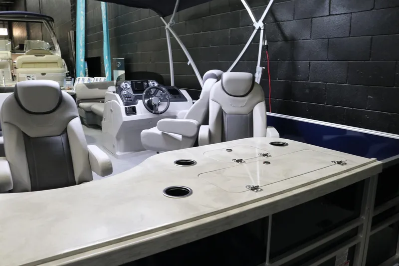 Slide: The Image of 2023 Sylvan L3 ENT boat interior with modern seating and steering console. - 24