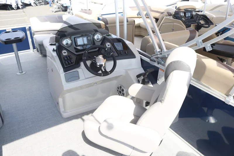 Slide: The Image of 2023 Sylvan L3 ENT boat interior with modern helm and comfortable seating. - 7