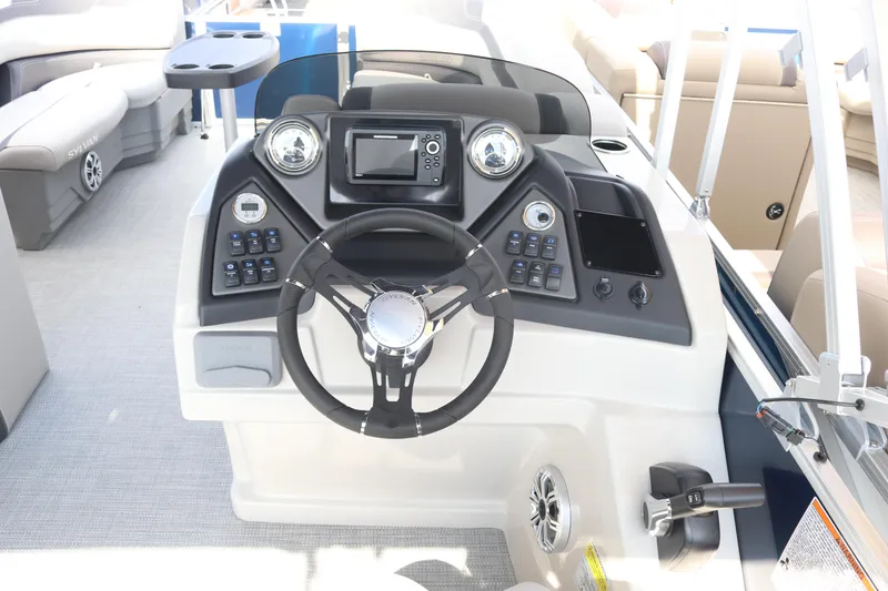 Slide: The Image of 2023 Sylvan L3 ENT boat dashboard with steering wheel and control panel. - 8