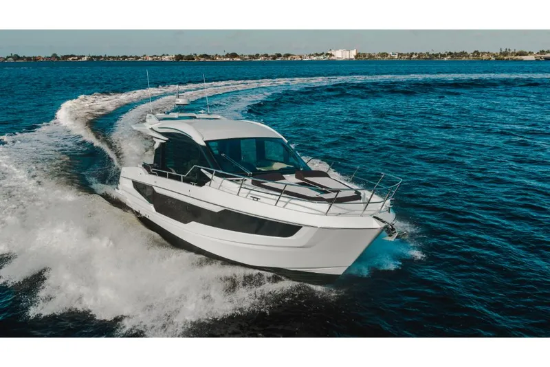Slide: The Image of 2023 Galeon 410 HTC luxury yacht cruising on open water. - 12