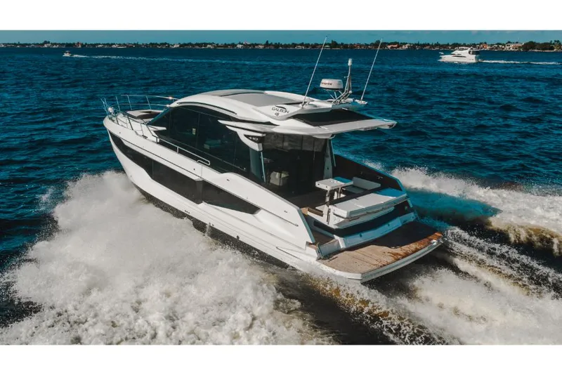 Slide: The Image of 2023 Galeon 410 HTC luxury yacht cruising on open water. - 18