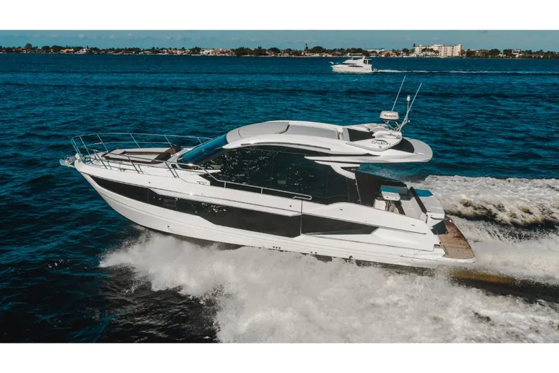 Slide: The Image of 2023 Galeon 410 HTC luxury yacht cruising on open water. - 19