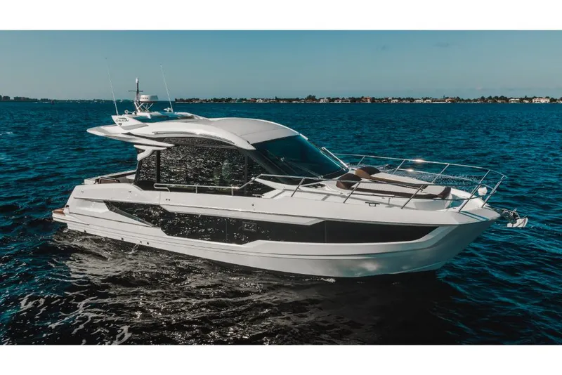 Slide: The Image of 2023 Galeon 410 HTC luxury yacht cruising on open water. - 2