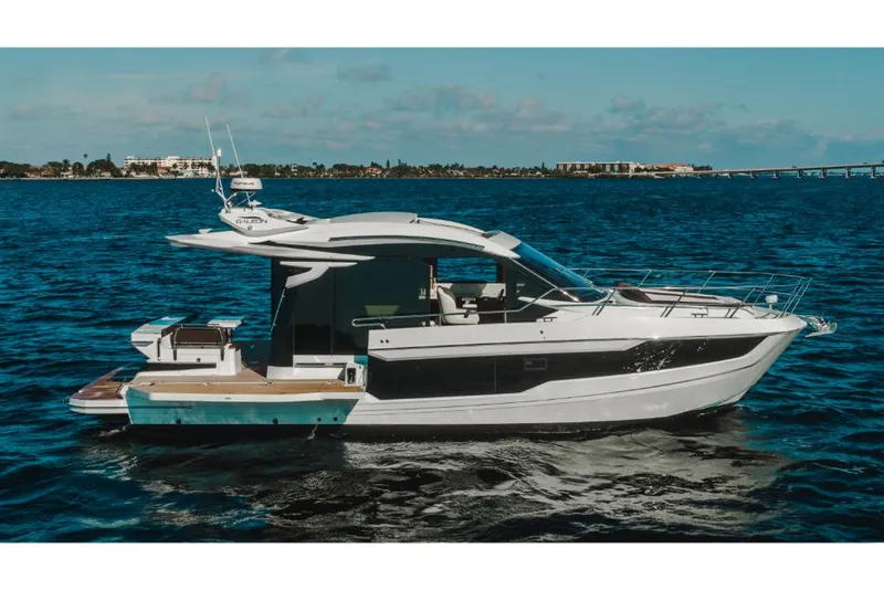 Slide: The Image of 2023 Galeon 410 HTC luxury yacht cruising on open water. - 22