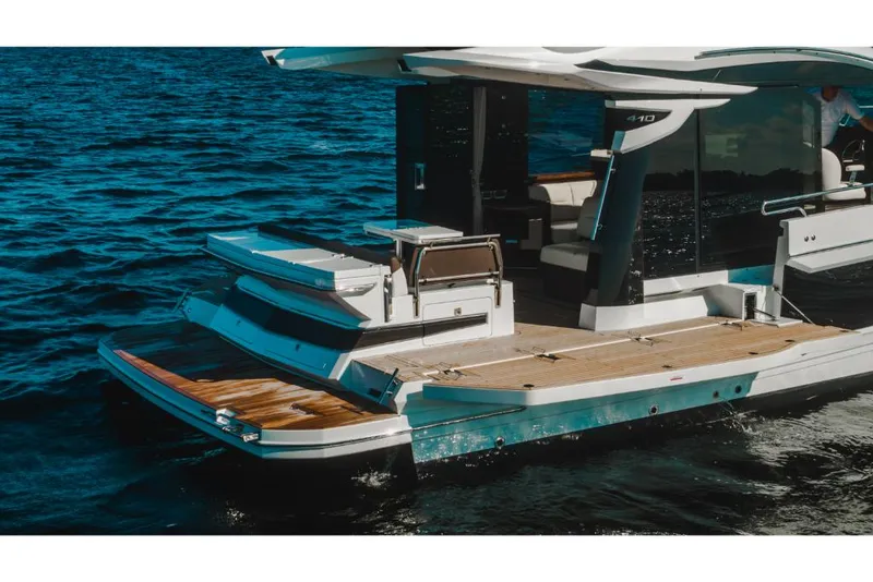 Slide: The Image of 2023 Galeon 410 HTC luxury yacht on water, featuring spacious deck and modern design. - 23