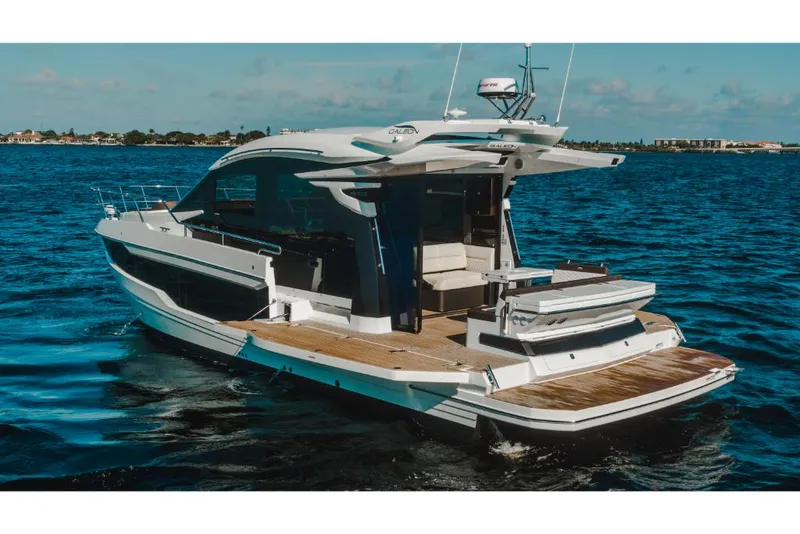 Slide: The Image of 2023 Galeon 410 HTC luxury yacht cruising on open water. - 25