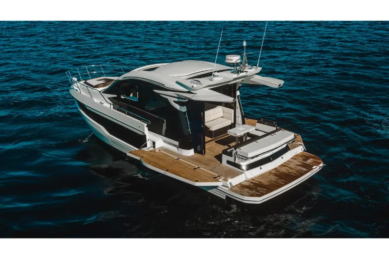 Slide: The Image of 2023 Galeon 410 HTC luxury yacht cruising on open water. - 26