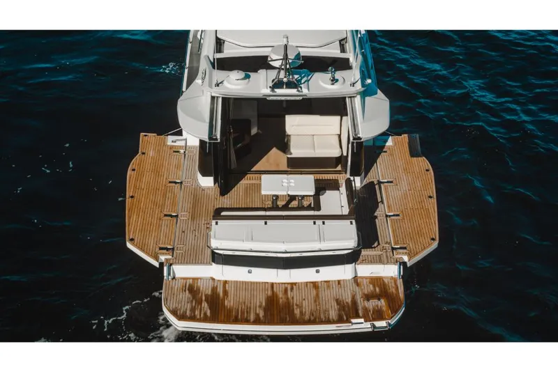Slide: The Image of 2023 Galeon 410 HTC yacht with spacious teak deck on water. - 28