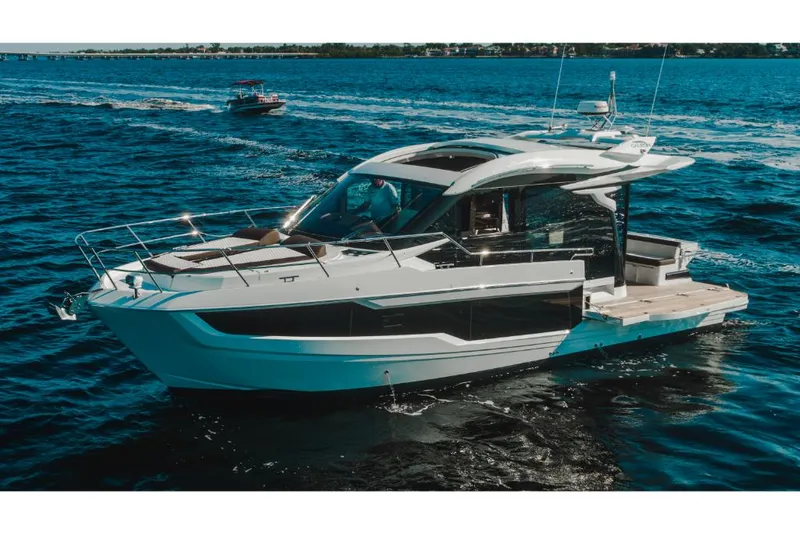 Slide: The Image of 2023 Galeon 410 HTC luxury yacht cruising on open water. - 32