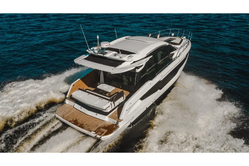 Slide: The Image of 2023 Galeon 410 HTC luxury yacht cruising on open water. - 6