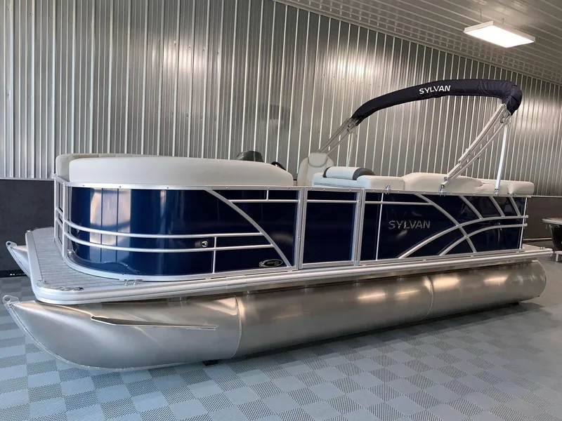 Slide: The Image of 2023 Sylvan Mirage 8520 Cruise pontoon boat in a showroom setting. - 0