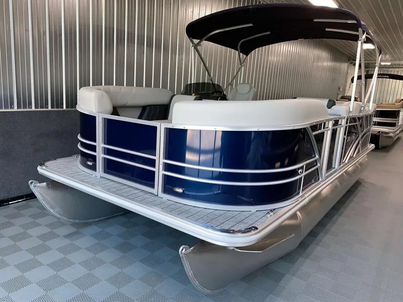 Slide: The Image of 2023 Sylvan Mirage 8520 Cruise pontoon boat in a showroom, featuring sleek design and canopy. - 1