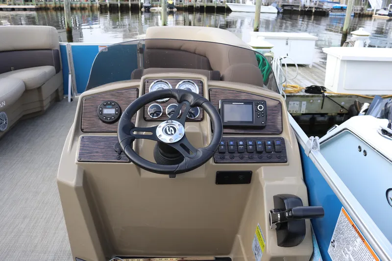 Slide: The Image of 2023 Sylvan Mirage 8520 Cruise boat dashboard with steering wheel and control panel. - 14