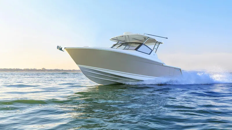 Slide: The Image of 2023 Bertram 28XC boat cruising on open water. - 0