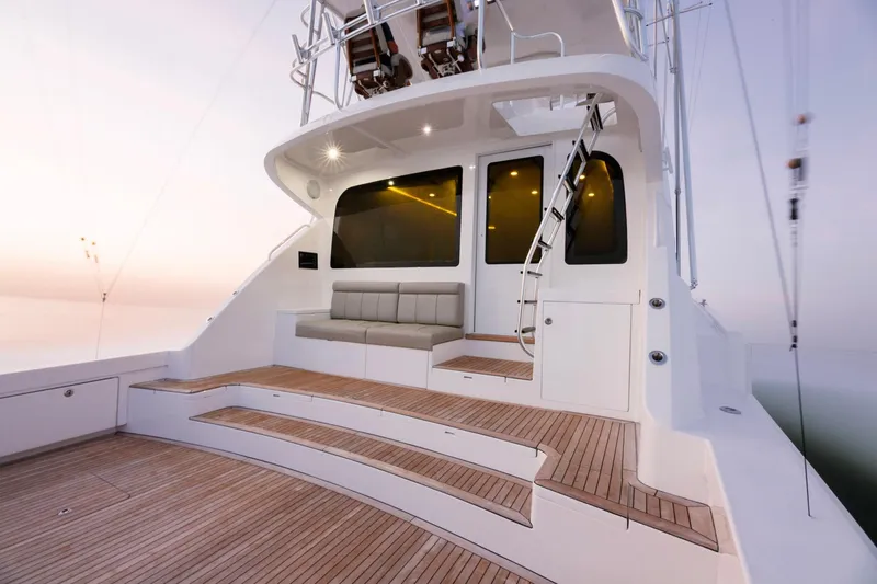 Slide: The Image of 2023 Bertram 61 Convertible yacht deck with seating and ladder. - 11
