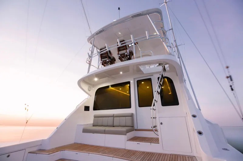 Slide: The Image of 2023 Bertram 61 Convertible yacht with spacious deck and modern seating. - 12