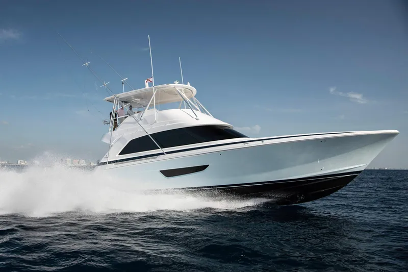 Slide: The Image of 2023 Bertram 61 Convertible yacht cruising on open water. - 2
