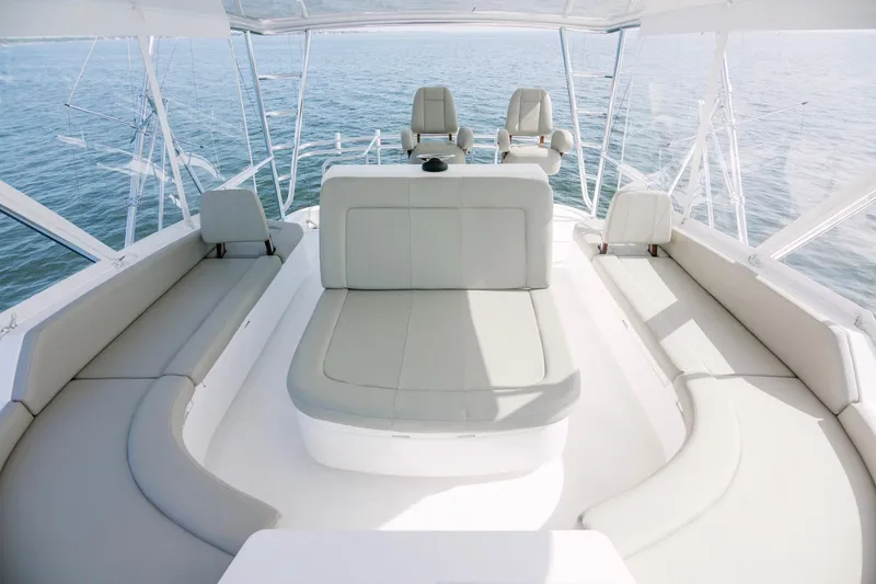 Slide: The Image of 2023 Bertram 61 Convertible yacht interior with luxurious seating and ocean view. - 21