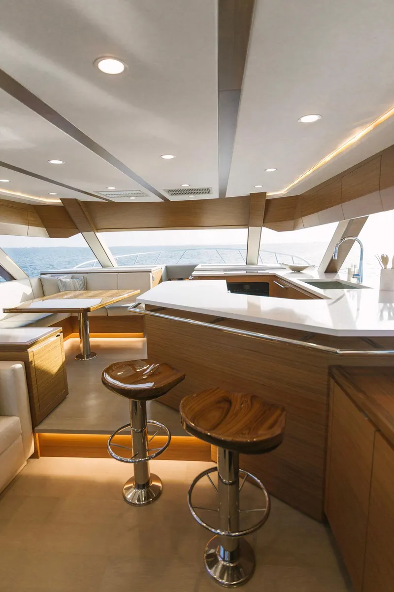 Slide: The Image of Modern interior of 2023 Bertram 61 Convertible yacht with sleek design and wooden accents. - 24