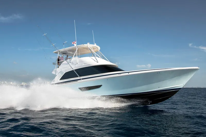 Slide: The Image of 2023 Bertram 61 Convertible yacht cruising on open water. - 3