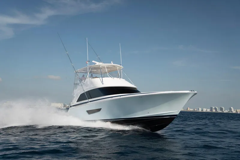 Slide: The Image of 2023 Bertram 61 Convertible yacht cruising on open water. - 4