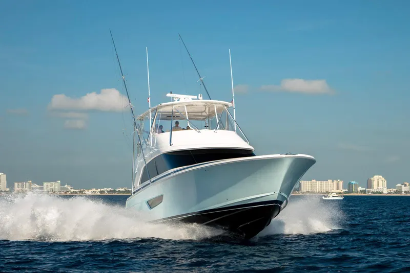 Slide: The Image of 2023 Bertram 61 Convertible yacht cruising on open water. - 5