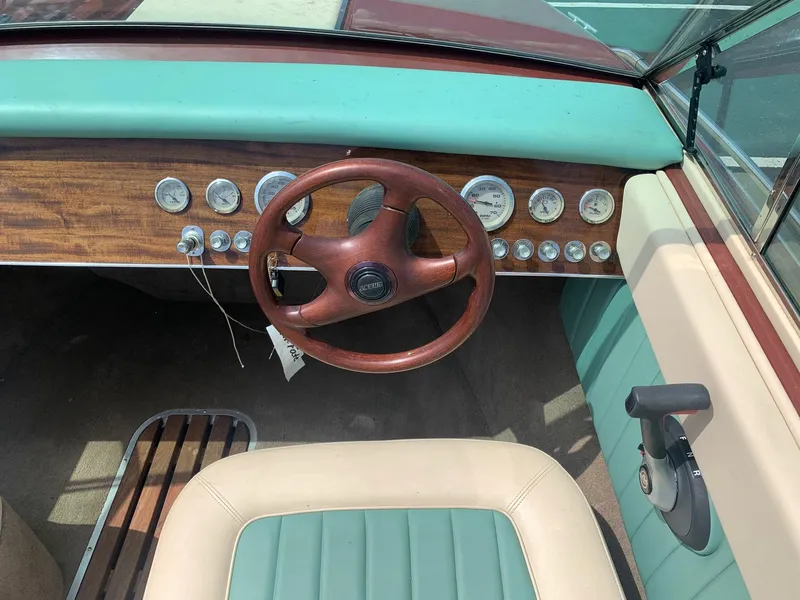 Slide: The Image of 2005 Coronado Custom boat dashboard with wooden steering wheel and vintage gauges. - 12