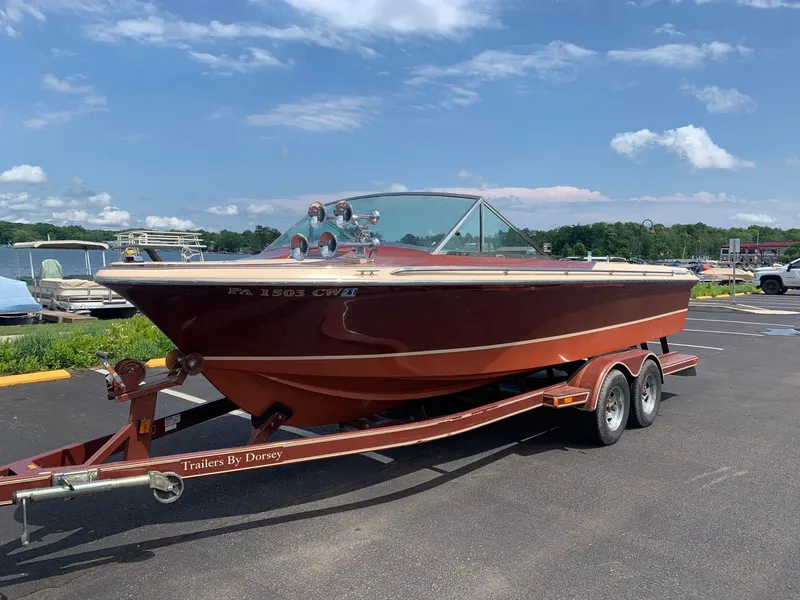 Slide: The Image of 2005 Coronado Custom boat on a trailer in a parking lot. - 2