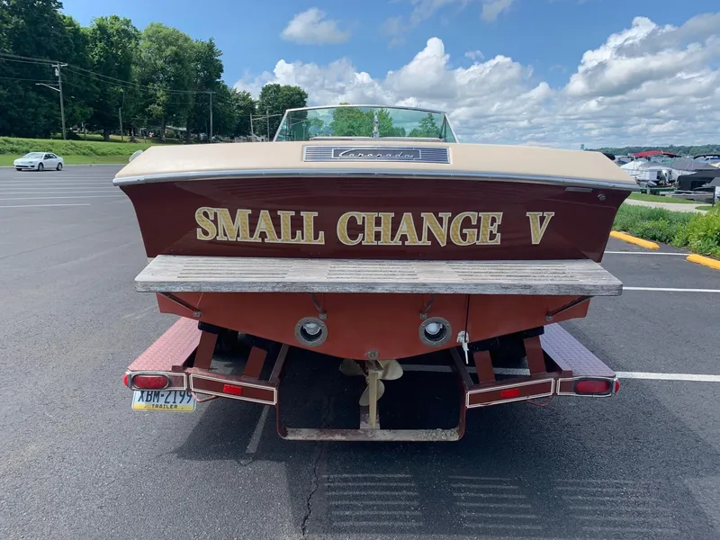 Slide: The Image of 2005 Coronado Custom boat Small Change V parked in a lot under a blue sky. - 4